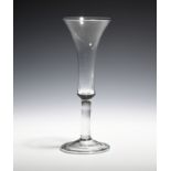 An ale glass c.1730, with a long bell bowl raised on a plain stem above a folded foot, 20.4cm.