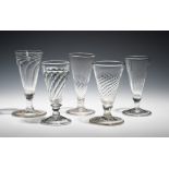 Five short ale glasses c.1750, all with wrythen moulding to the conical bowls, raised on plain and