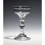 A small sweetmeat glass c.1740, the plain ogee bowl raised on a teared knop above a domed and folded