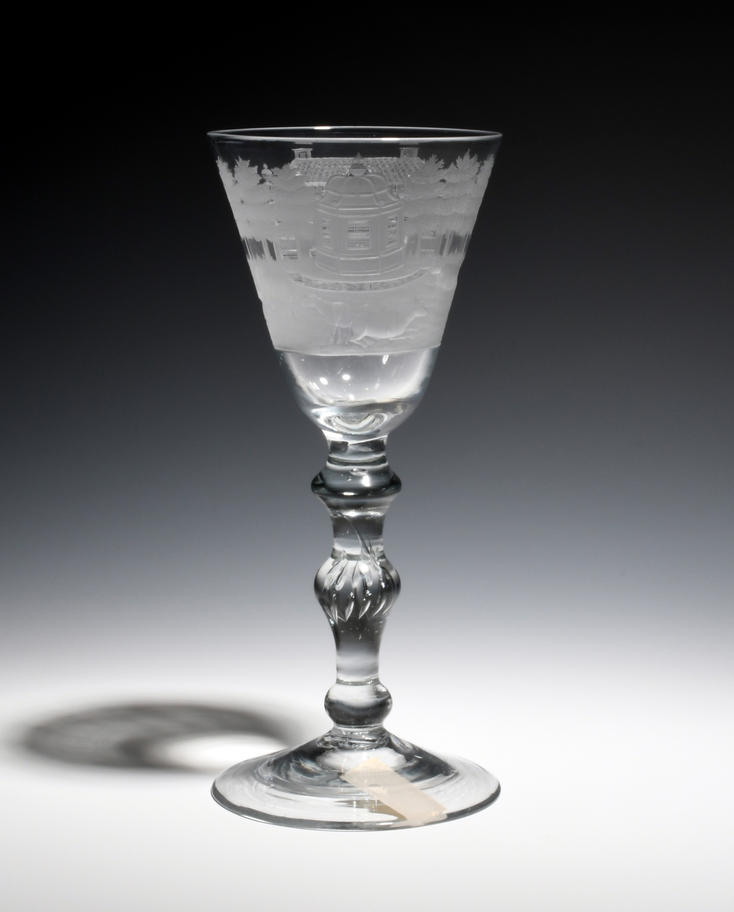 A Dutch-engraved light baluster glass c.1750, engraved in the manner of Jacob Sang with a continuous