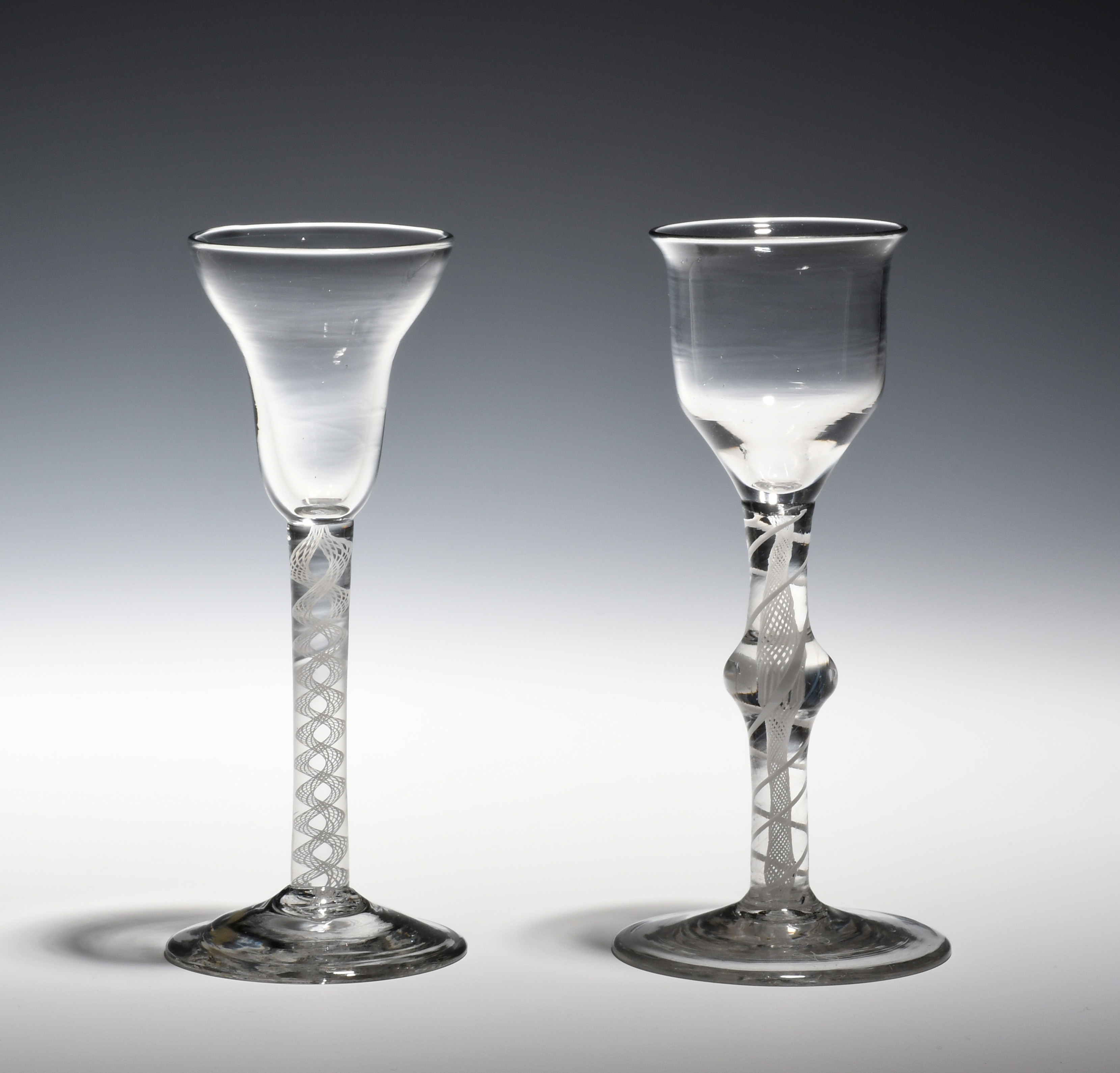 Two wine glasses c.1760-70, one with a pan-top bowl on an opaque twist stem, the other with an