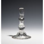 A glass taper stick c.1750, with inverted pedestal stem above a panel moulded foot, 12.8cm.