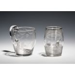 Two glass mugs c.1800-10, one barrel-shaped and engraved with hops and barley, the other with