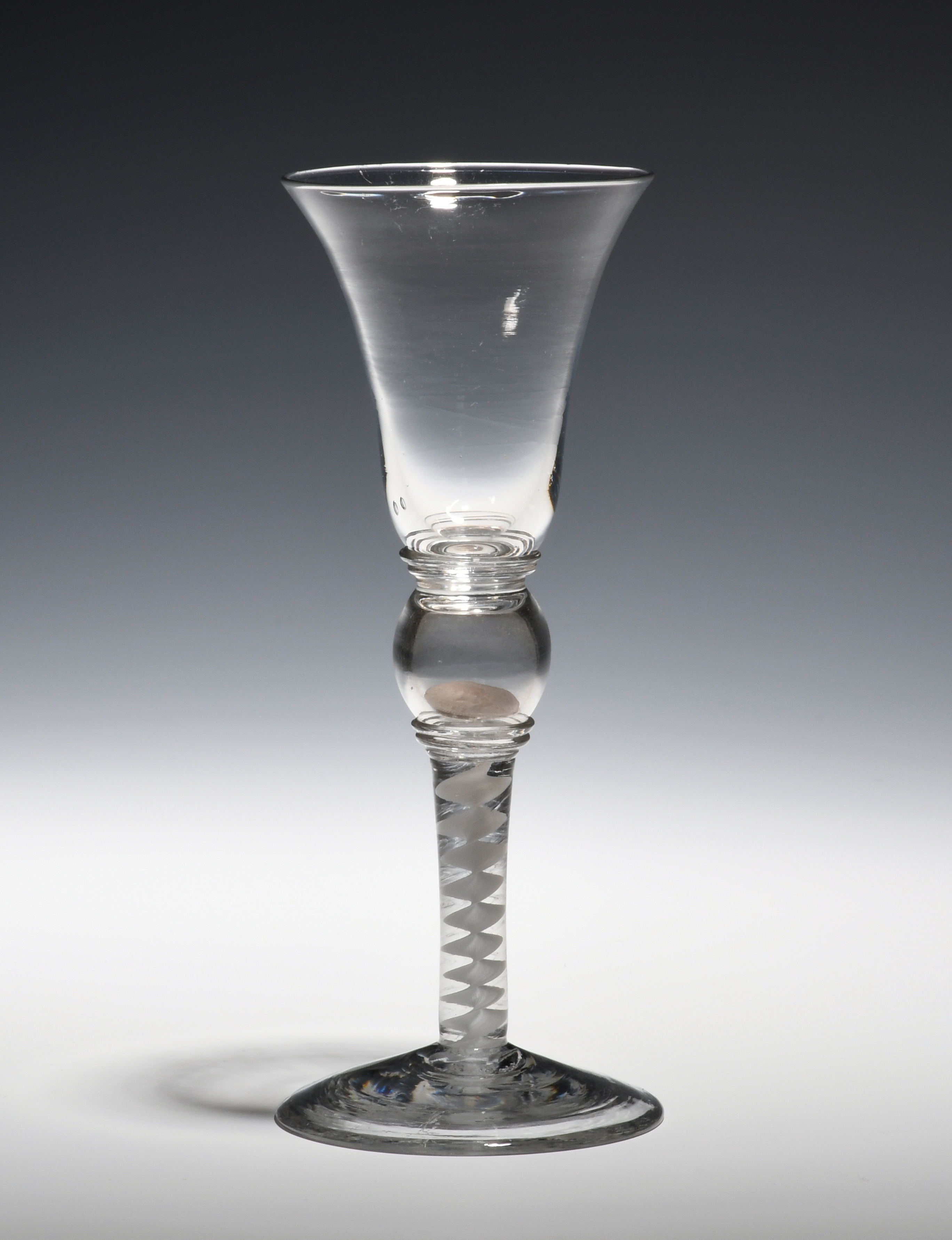 A coin wine glass c.1770, the bell bowl raised over a hollow knop containing a 3d coin of James