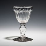 A sweetmeat glass c.1750, the bowl moulded with flutes above a hollow stem and plain foot, 15.3cm.