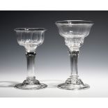 Two sweetmeat glasses c.1750, with panel moulded ogee bowls raised on pedestal stems above domed and