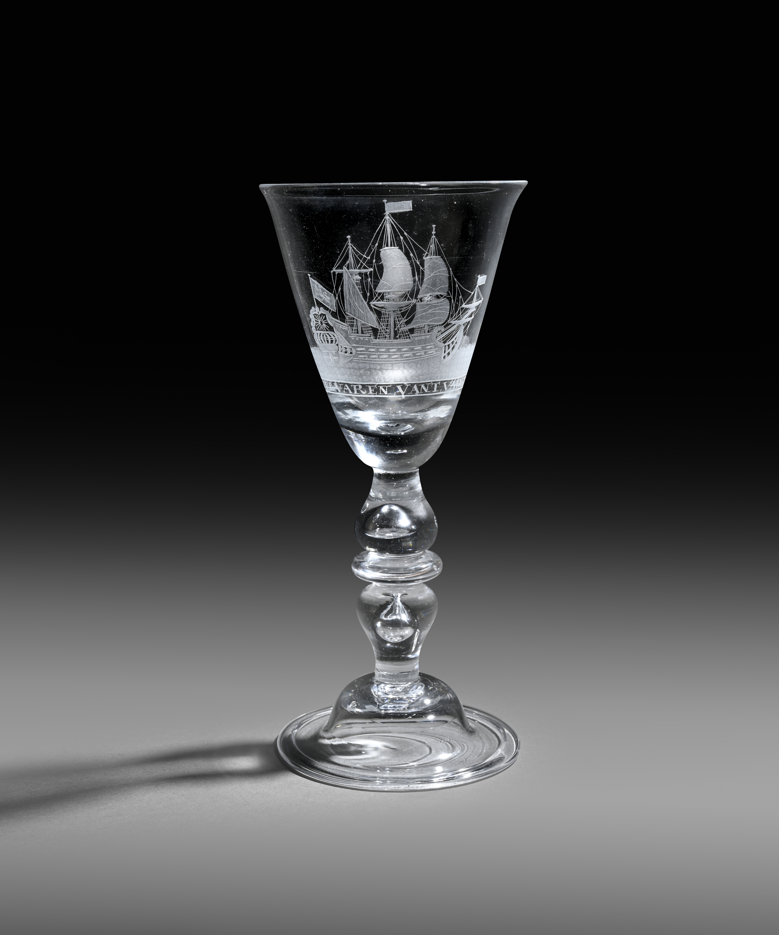 A Dutch-engraved light baluster goblet c.1745-50, the generous rounded funnel bowl engraved with a