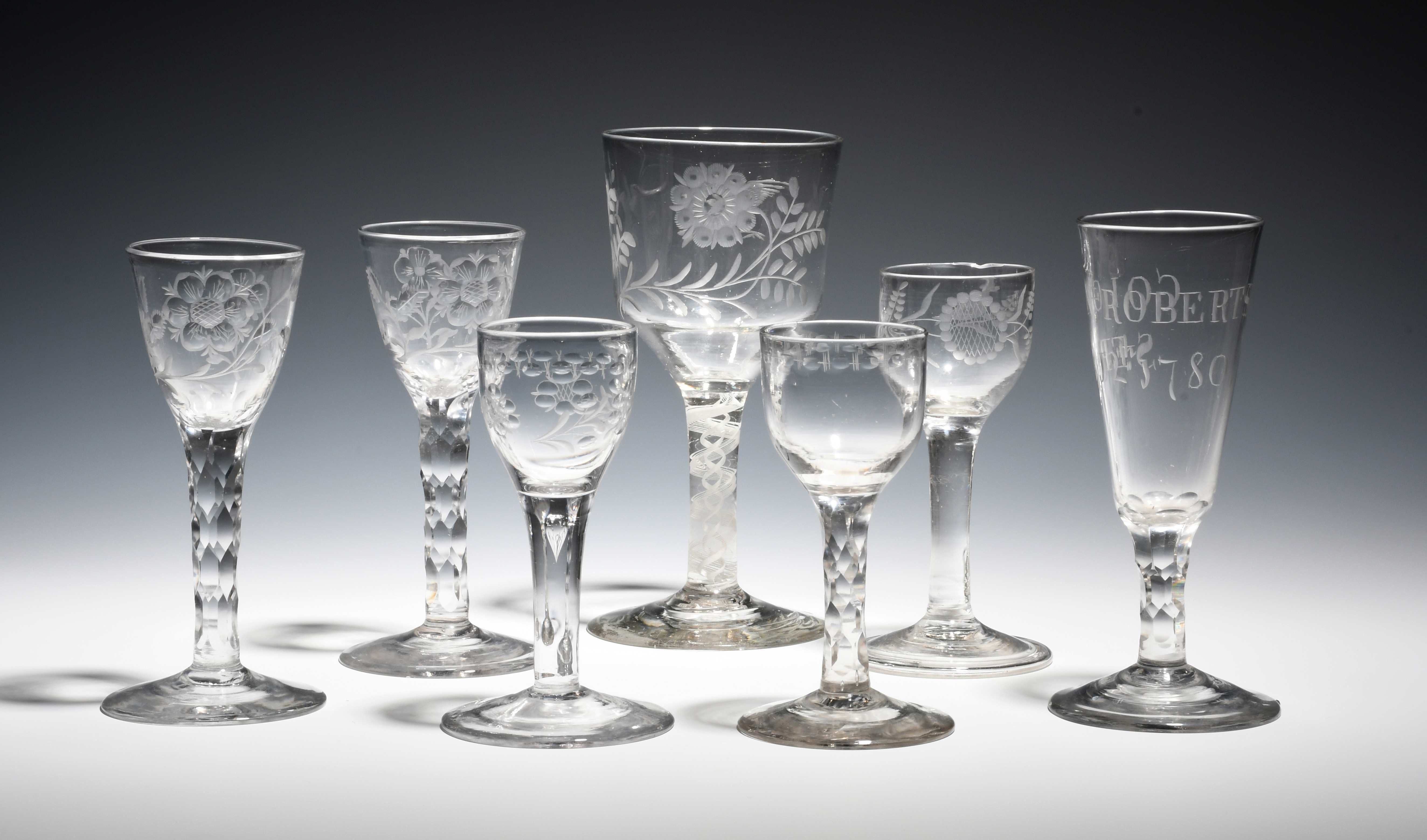 Seven wine glasses c.1760-85, one with a generous ogee bowl engraved with a bird and rose spray on a