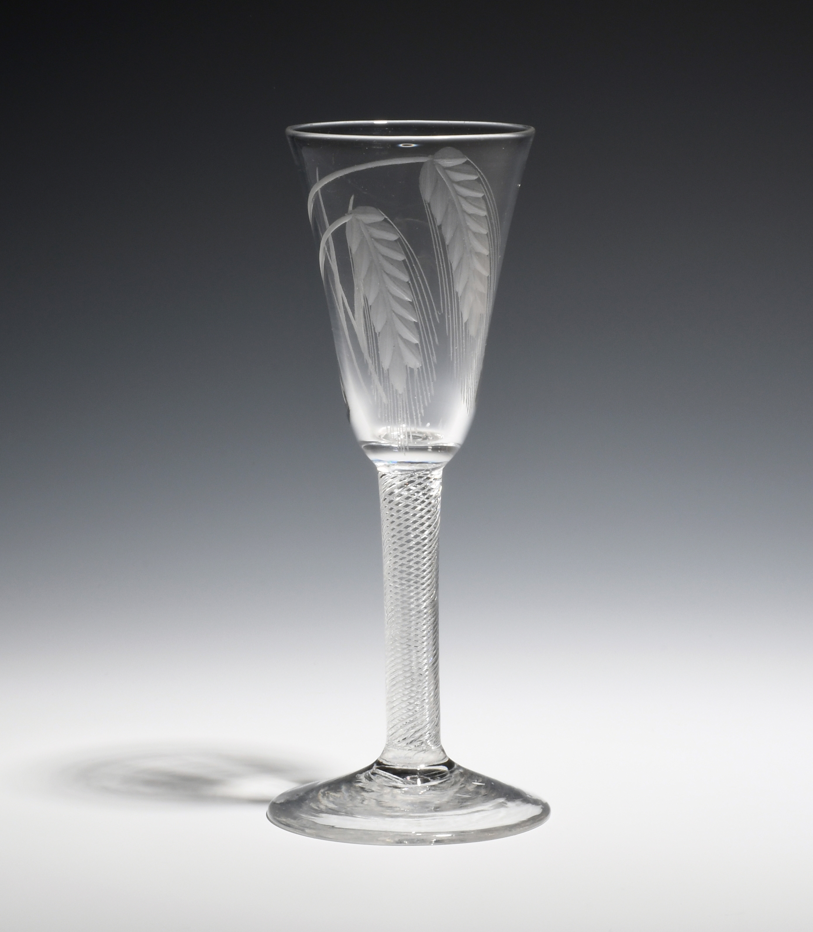 An ale glass c.1750, the round funnel bowl engraved with two ears of barley, raised on a multi-