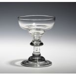A baluster sweetmeat glass c.1720, the shallow ogee bowl raised on a baluster stem above a domed and
