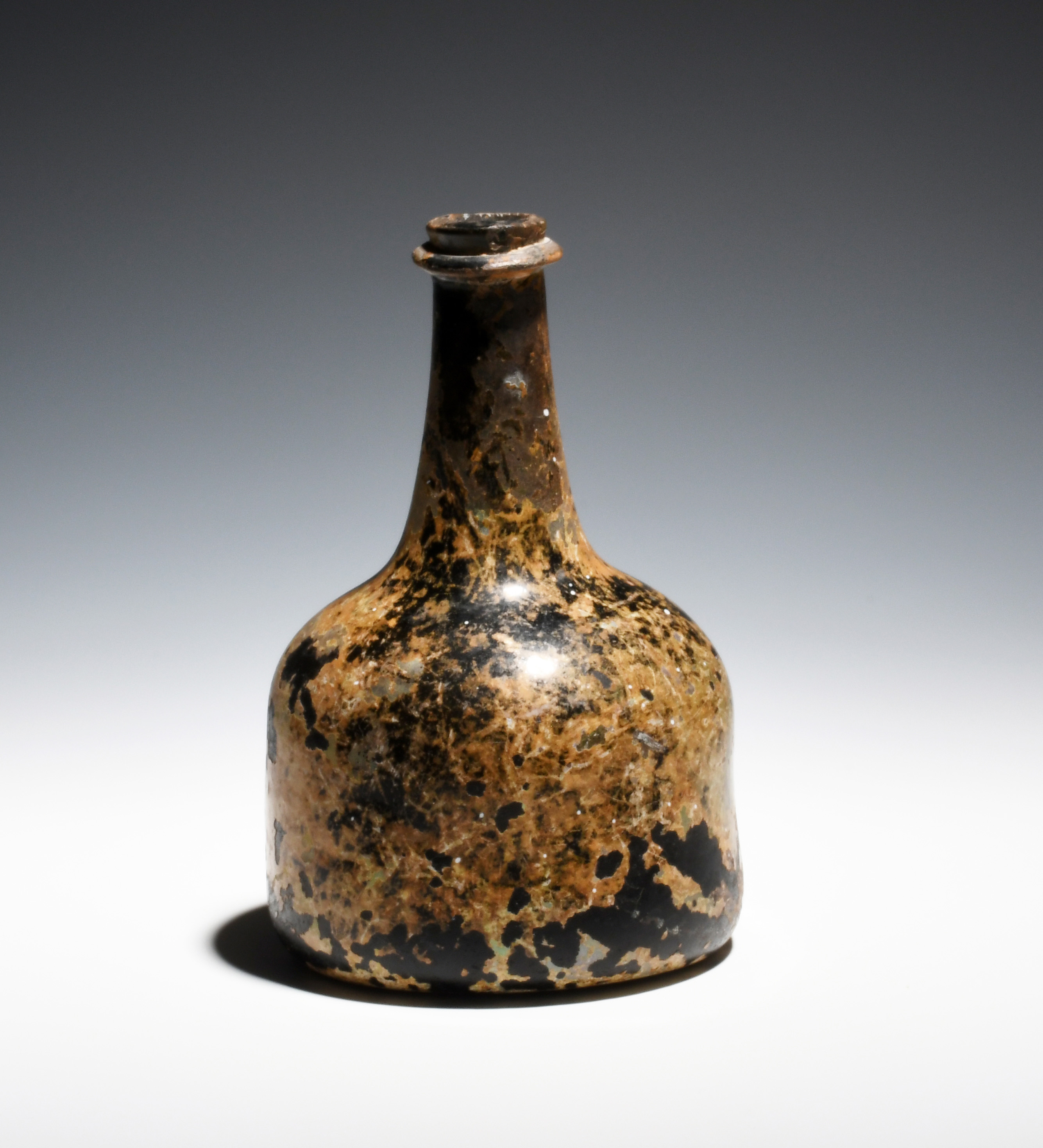 A small English glass wine bottle c.1720, of squat mallet form, with tapering neck, string rim and