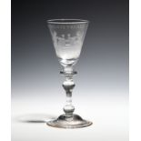 A Dutch-engraved 'Newcastle' type goblet c.1750, the round funnel bowl engraved with a drinking