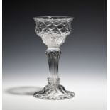 A sweetmeat glass c.1750, the ogee bowl with honeycomb moulding, raised on a pedestal stem above a
