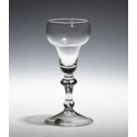 A balustroid wine glass c.1730, with double ogee bowl raised on a stem with angular and basal