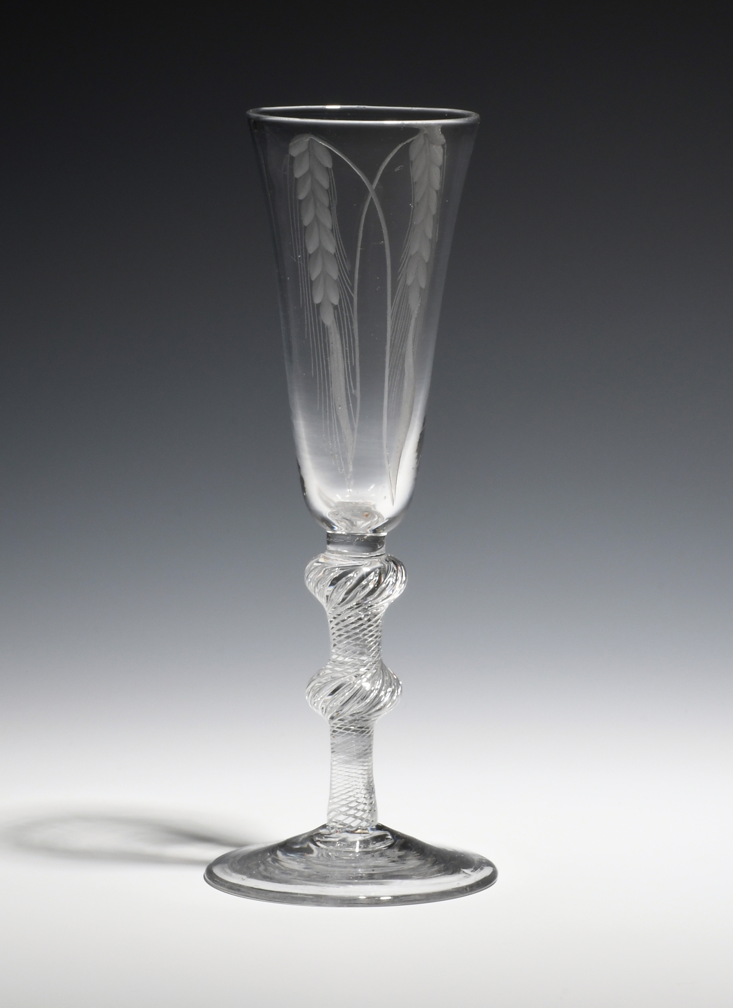 An ale glass c.1750, the round funnel bowl engraved with two ears of barley, raised on a double-