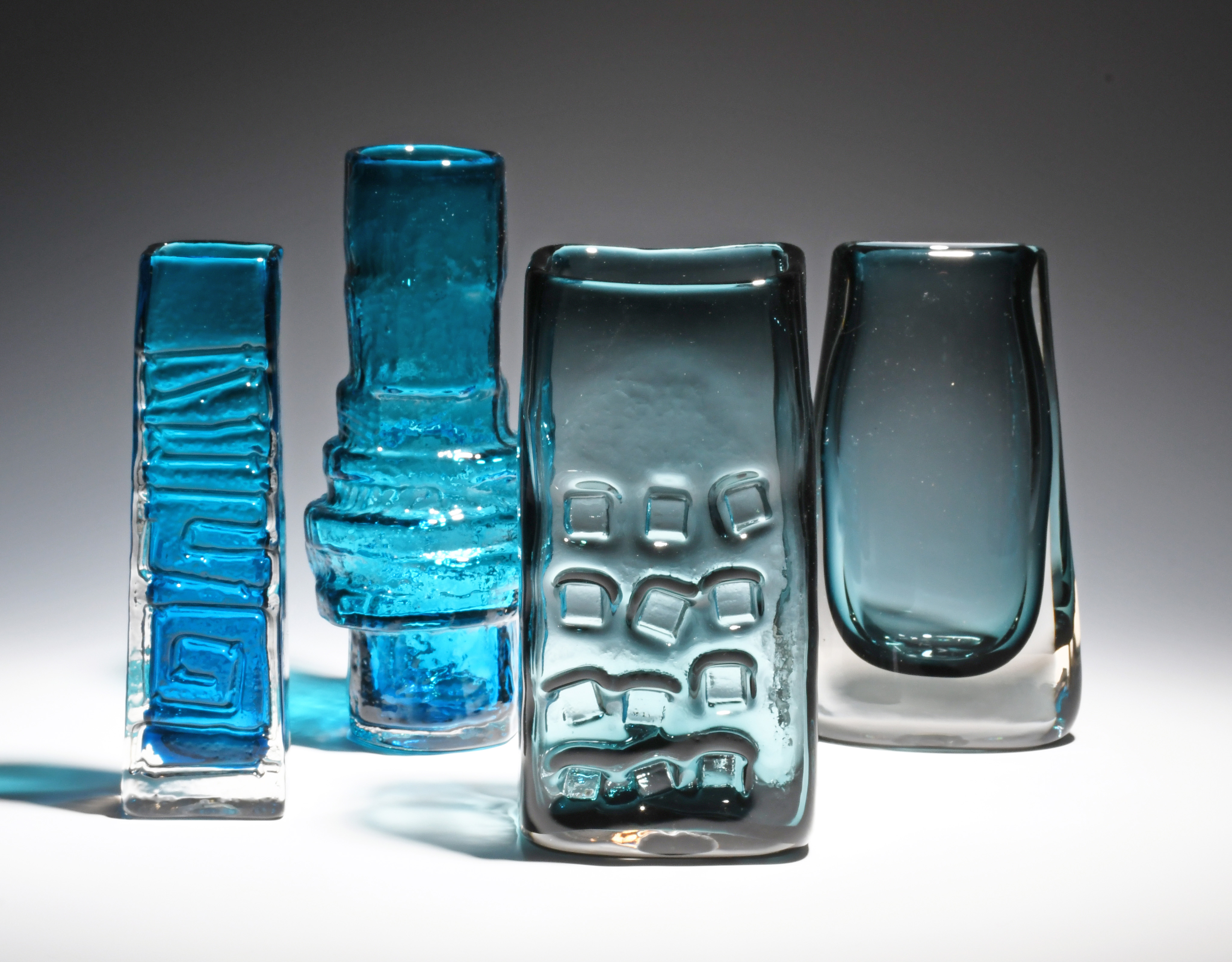Four Whitefriars glass vases 20th century, including an Indigo rectangular slab vase, a Kingfisher
