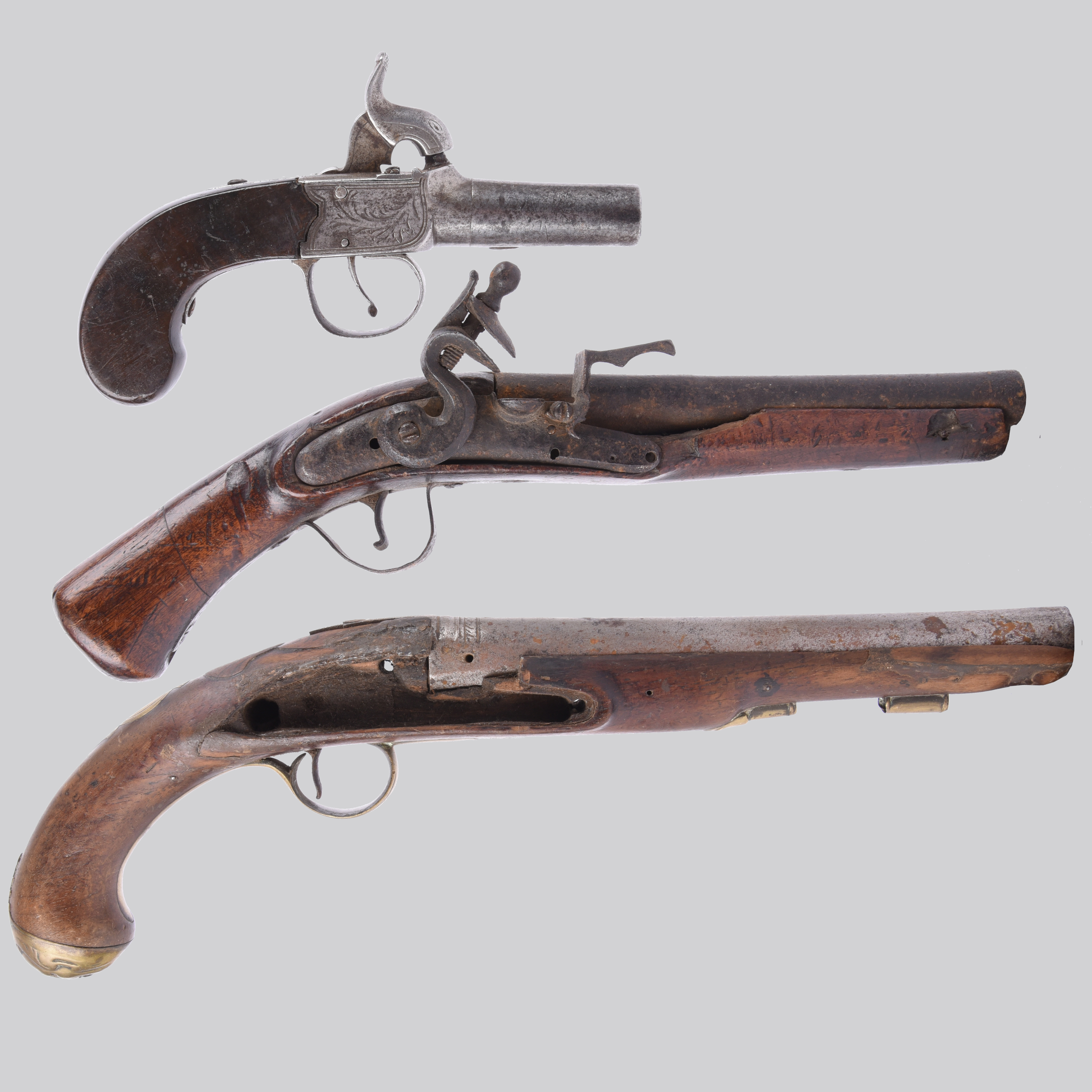 The major parts of three antique pistols: i) the barrel, stock and external lock parts of a