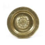 A GERMAN BRASS ALMS DISH NUREMBERG, 17TH CENTURY with a central repousse whorl boss and a Gothic