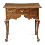 A GEORGE II OAK LOWBOY C.1740-50 the boarded top with a moulded edge, above three fruitwood banded