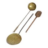 THREE DOMESTIC UTENSILS LATE 17TH / EARLY 18TH CENTURY comprising: a brass skimmer with a wrought