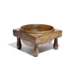 A TREEN DAIRY WHEY BOWL EARLY 19TH CENTURY on four turned legs 16.5cm high, 26.2cm wide Catalogue