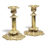 A PAIR OF WILLIAM IV GILT BRASS CANDLESTICKS C.1830-40 in French Rococo style, decorated with