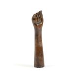 A TREEN PIPE TAMPER LATE 18TH / EARLY 19TH CENTURY in the form of an arm with a clenched fist and