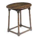 AN OAK OVAL OCCASIONAL TABLE LATE 17TH / EARLY 18TH CENTURY on ring turned column supports united by