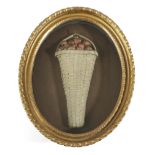 A REGENCY FELTWORK PICTURE EARLY 19TH CENTURY depicting a basket of strawberries, in a glazed oval
