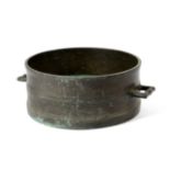 A BRONZE BUSHEL MEASURE 18TH CENTURY the moulded body with a pair of angular lug handles, the rim