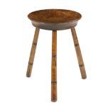 AN ELM MILKING STOOL LATE 19TH / EARLY 20TH CENTURY with a dished seat and ring turned legs 38.5cm