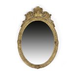 A FRENCH LOUIS XIV GILTWOOD WALL MIRROR EARLY 18TH CENTURY the later oval plate within a leaf and