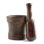 A TREEN WALNUT PESTLE AND MORTAR EARLY 18TH CENTURY both with remains of a painted finish, the