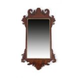 A GEORGE II MAHOGANY FRET-FRAME WALL MIRROR C.1740 the later rectangular plate with arched top