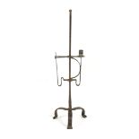 A WROUGHT IRON ADJUSTABLE FLOOR STANDING CANDLEHOLDER 18TH CENTURY on tripod supports 74.2cm high