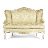 A FRENCH WHITE PAINTED AND GILTWOOD CANAPE IN LOUIS XV STYLE 19TH CENTURY covered in gold silk