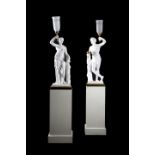 A PAIR OF REGENCY PLASTER TORCHERE FIGURES OF BACCHUS AND FLORA IN THE MANNER OF HUMPHREY HOPPER,