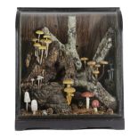 A CARVED WOOD MUSHROOM DIORAMA the naturalistic setting with fallen branches, applied with various