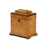 A GEORGE IV BURR ELM TEA CADDY C.1825 of sarcophagus shape, the interior with twin divisions and