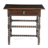 A WILLIAM AND MARY OAK SIDE TABLE C.1690 the boarded top with a moulded edge, above a frieze drawer,