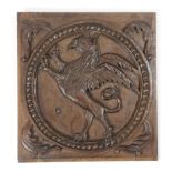 A RELIEF CARVED OAK PANEL OF A GRIFFIN 17TH CENTURY the rampant beast within a beaded border and