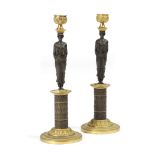 A PAIR OF GRECIAN REVIVAL GILT AND PATINATED BRONZE FIGURAL CANDLESTICKS EARLY 19TH CENTURY each
