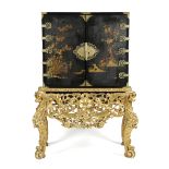 A BLACK JAPANNED CABINET ON A GILTWOOD STAND EARLY 18TH CENTURY AND LATER with gilt raised
