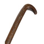 A FOLK ART TREEN ASH WALKING STICK 19TH CENTURY naively engraved with a hunting scene with horse,