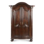 A FRENCH PROVINCIAL CHESTNUT ARMOIRE 18TH CENTURY of arched form, with moulded scroll decoration,