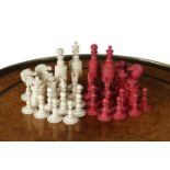 A BONE BARLEYCORN PATTERN CHESS SET 19TH CENTURY natural and stained red (32) the king: 9.8cm