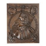 A RELIEF CARVED OAK ROMAYNE BUST PANEL 17TH CENTURY of a bearded man, with scrolling leaf