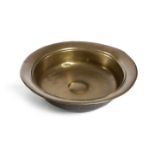 A 17TH CENTURY BRASS ROSE WATER BOWL POSSIBLY FLEMISH with a raised central boss 41.1cm diameter