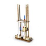 A CROQUET SET ON STAND FIRST HALF 20TH CENTURY with four mallets, three by Spalding and an