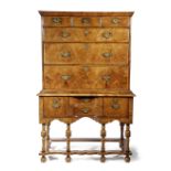 A QUEEN ANNE WALNUT CHEST ON STAND EARLY 18TH CENTURY the crossbanded top above three short and
